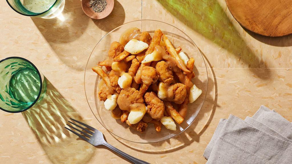 Chicken Poutine · Fresh cut french fries topped with crispy chicken bites, cheese curds, and gravy.