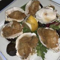 Sautéed Oysters (6) · Freshly shucked blue point oysters, light fried and sautéed in garlic butter.