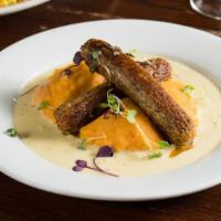 Stoemp Saucisse · Sausage served with creamy carrot mashed potatoes and mustard sauce.