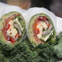 Veggie Wrap · Green zucchini, yellow squash, red, yellow and green peppers with hummus on a gourmet wrap.