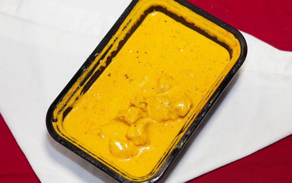 Butter Chicken · Clay oven baked chicken, cooked in rich tomato butter cream sauce.