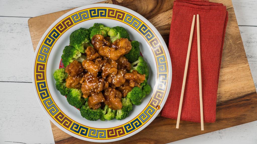 Sesame Chicken · Spicy. Hot and spicy, fried dark meat chicken cooked in spicy sauce with sesame seeds on top and broccoli at the bottom.