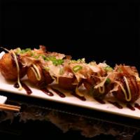 Tako Yaki (6 Pcs) · Rounded balls containing pieces of octopus.