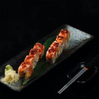 Cowboy Roll · spicy kani, shrimp,mango inside, topped with seared salmon, chef`s special garlic chili sauc...