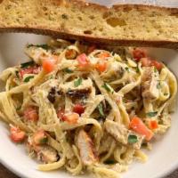 Creamy Chicken Pesto Pasta · Blackened chicken breast, diced tomatoes, fettuccine topped with Parmesan cheese. Served wit...