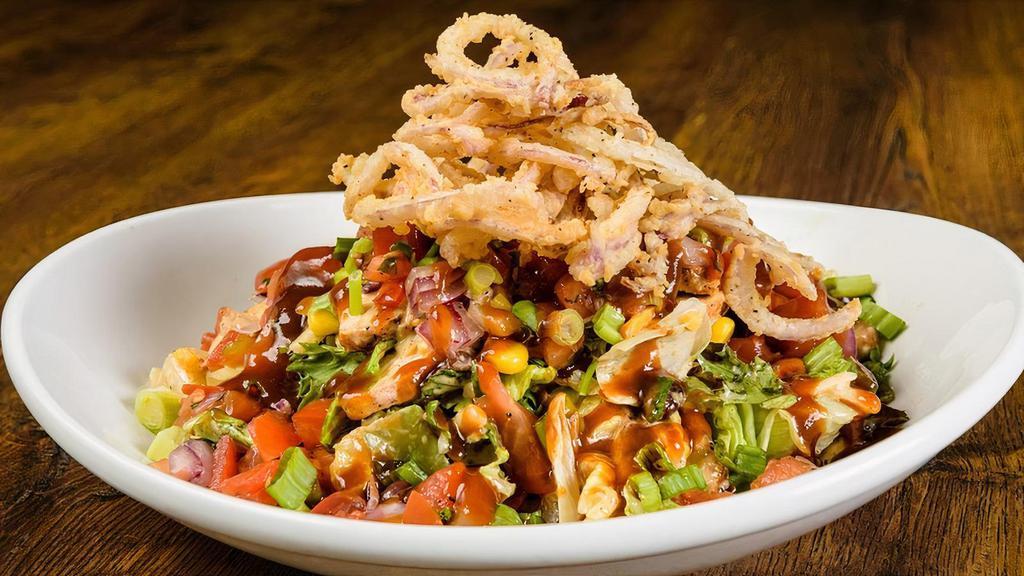 Southwest Bbq Chicken Salad · Blackened chicken, black bean-corn salsa, Monterey Jack and cheddar cheeses, pico de gallo, scallions, field greens, Cajun ranch dressing and BBQ sauce, topped with crispy onion tanglers