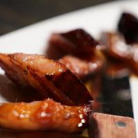 North Country Smokehouse Bacon · Flame broiled and served with a maple bourbon reduction and finished with sea salt.