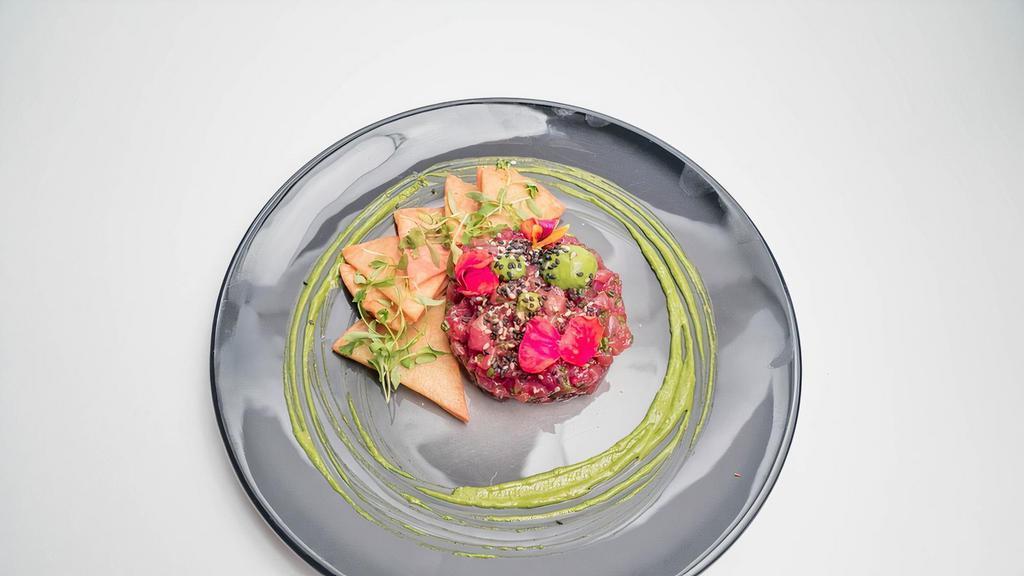 Tuna Tartare · with pressed avocado, soy, sesame and cucumber, finished with a Yuzu Citrus Emulsion