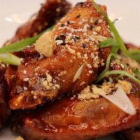 Thai Chicken Wings · Paired with crushed cashews and scallions, tossed in a Thai Sesame Sauce.