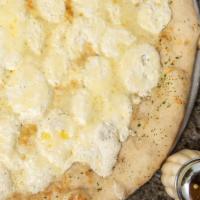 White Pizza · A sauceless pie topped with ricotta, mozzarella, and parmesan cheese.