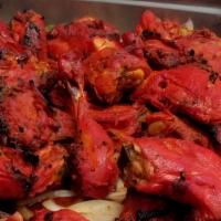 North Indian Tandoori Chicken Legs · Chicken legs marinated overnight in yogurt & spices, roasted in clay oven