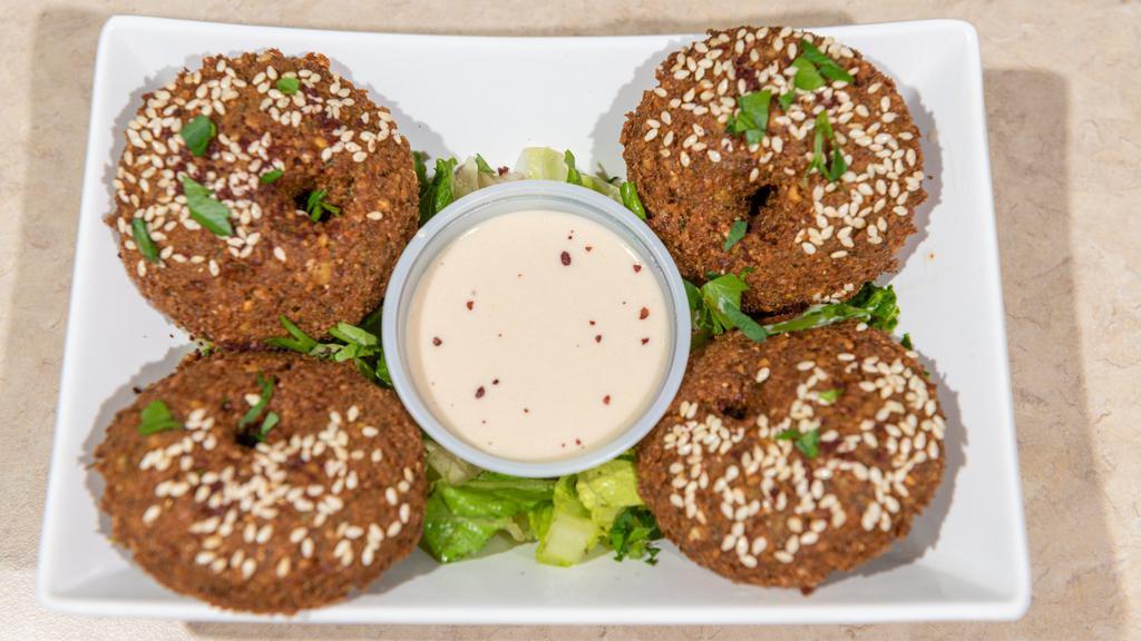 Falafel (4 Pieces) · Vegetarian. A deep-fried mixture of ground chickpeas, onions, and spices. Served with Tahini Sauce.