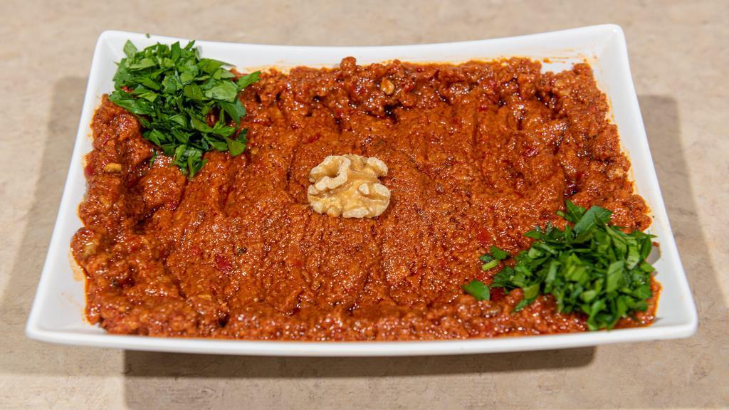 Muhammara · Spicy. Fresh red pepper, ground walnuts, bread crumbs, olive oil, pomegranate molasses, shatta, and cumin.