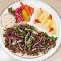 Lamb Shawarma Platter · Thin sliced Lamb, Sela Basmati Rice, Mediterranean Salad and Hummus.