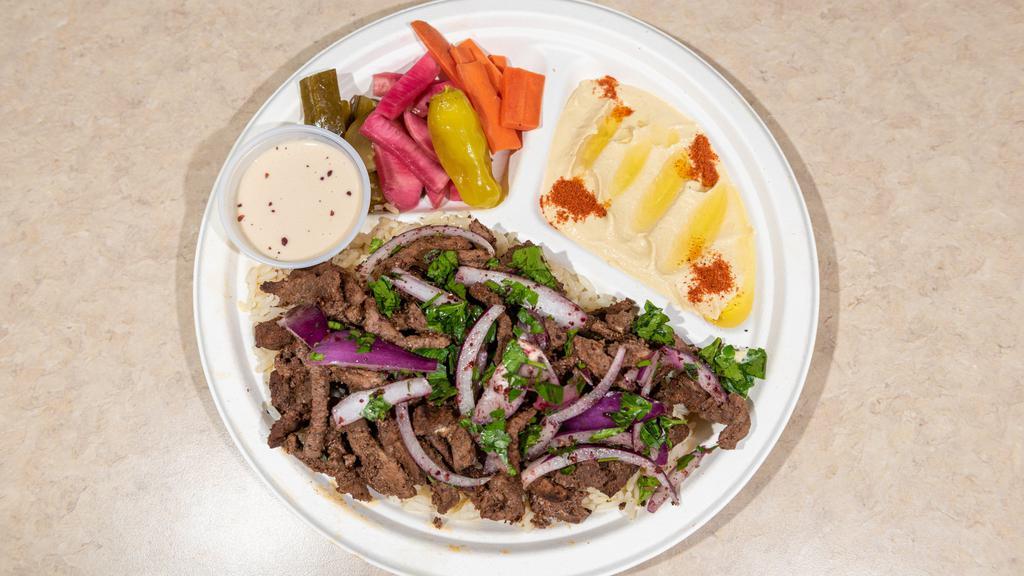 Beef Shawarma Platter · Halal. Thin sliced Beef shawarma, Served with Basmati sela rice, hummus, pickles and garnished with onions, parsley and tahini sauce.