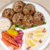 Falafel Platter · Vegetarian. Six pieces of falafels covered with sesame seeds. Served with hummus, Salad and ...