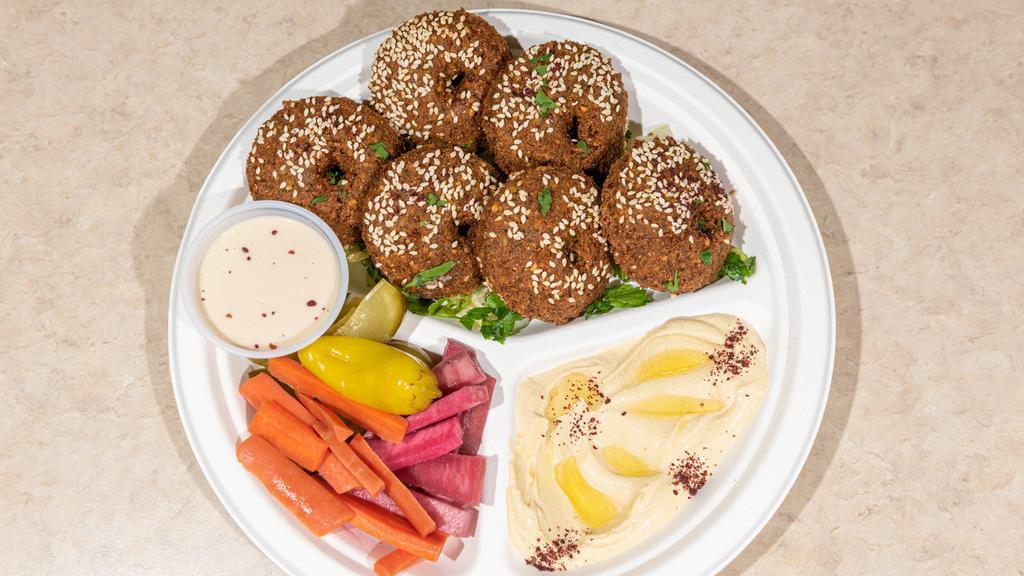 Falafel Platter · Vegetarian. Six pieces of falafels covered with sesame seeds. Served with hummus, Salad and tahini sauce.
