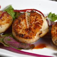 Grilled Sea Scallops · Grilled sea scallop with black pepper sauce.