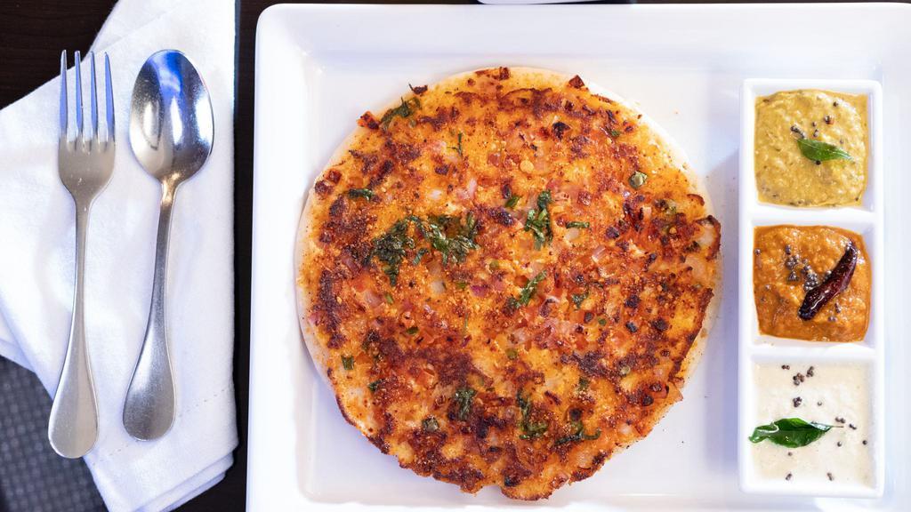 Masala Uthapam · South Indian soft pancake made of rice and lentil topped with onions, tomatoes, green chilies, cilantro, curry leaves and gun powder-milaigai podi.