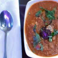 Ennai Kathirikkai Kuzhambu · Tamarind based tangy curry cooked with marinated egg-plant, onions and tomatoes.