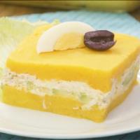 Causa De Pollo · Sculptured mashed potato infused with lime juice and yellow pepper layered with chicken and ...