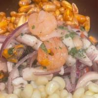 Ceviche De Mariscos · Mixture of seafood cooked in lime juice with onions and spices.