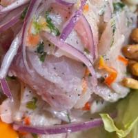 Ceviche De Pescado · Dice fish cooked in lime juice with onions and spices.