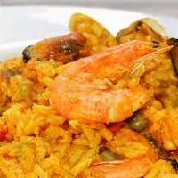 Arroz Con Mariscos · Peruvian style seafood rice a little similar to paella served with sarsa criolla.