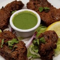 Boti Kebab · Succulent pieces of lamb marinated with ginger, chilies and freshly ground spices roasted in...