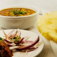 Chana Bhatura · White flour bread with saucy chickpeas served with pickles and onions.