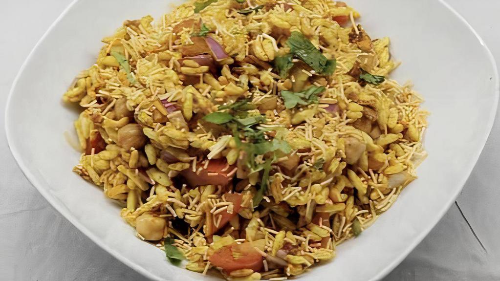Bhel Puri · Savory Indian Healthy snack consisting of puffed rice mixed with onions, tomatoes, mint and tamarind chutney, cilantro and sev ( crunchy seasoned noodles).