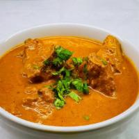 Chicken Curry · Chicken  prepared with spices in a tomato-onion gravy.