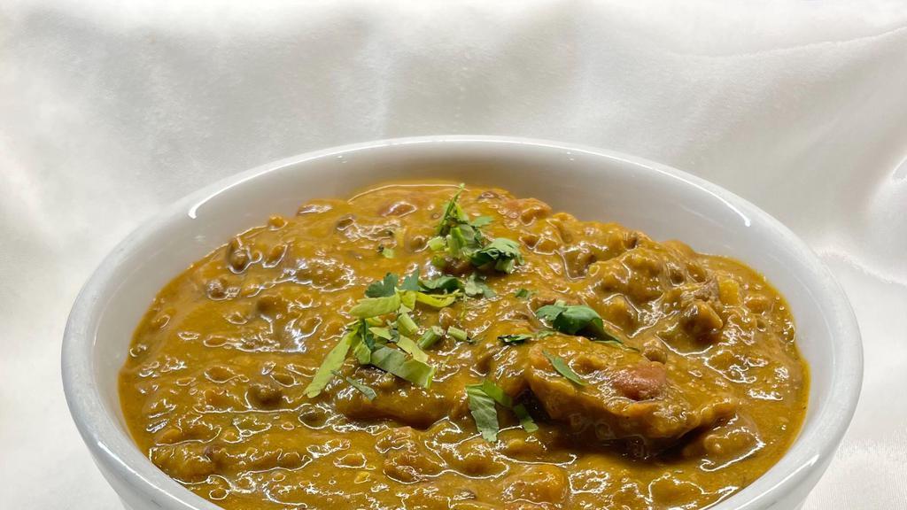 Dal Makhani · Black lentils cooked with cumin seeds, garlic, and spices.