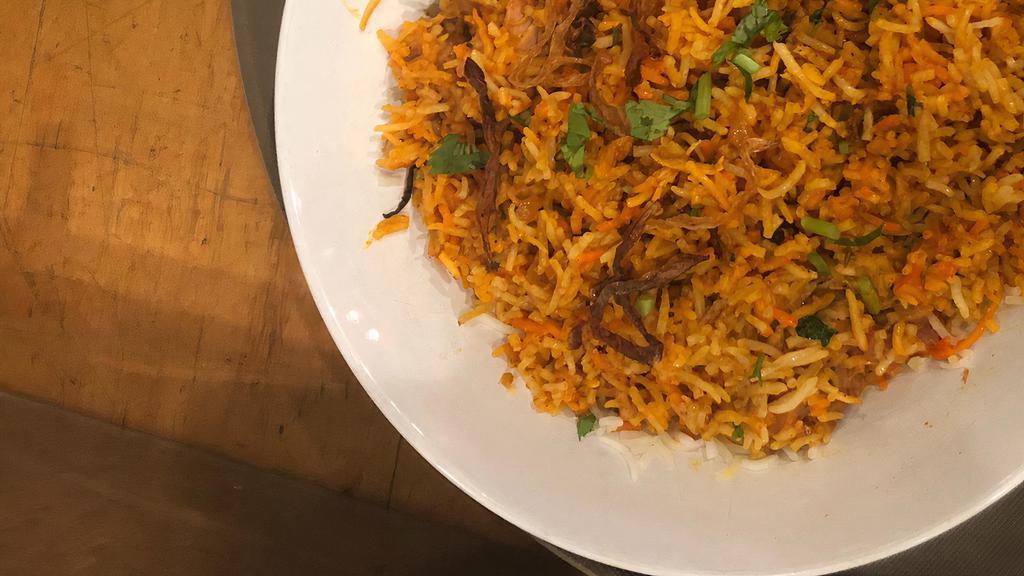 Chicken Biryani · Basmati rice cooked with chicken and spices served with raita.