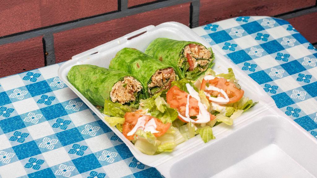 Chicken Wrap · Roasted chicken seasoned with spices. Wrapped in a spinach tortilla with garlic mayonnaise spread, lettuce, tomato, and feta cheese served with salad.