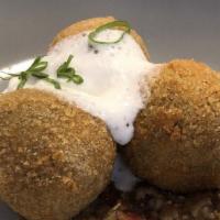 Mujaddara Croquette · Green lentil and rice croquette, makdous,
caramelized onions, bechamel, feta.
