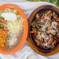 Fajitas Mixtas · Shrimp, steak, and chicken, served with rice and beans.