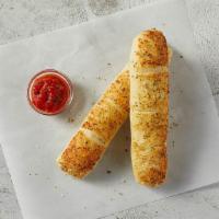 Breadsticks + Sauce · Fresh dough brushed with garlic sauce, cheese and seasoning.  Comes with sauce.