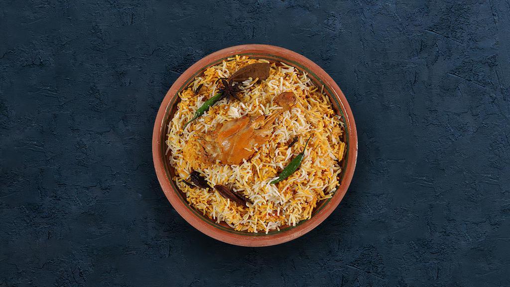 Chicken Dhum Biryani · Long grain basmati rice cooked with tender chicken and aromatic Indian herbs.