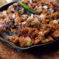 Pusit Sisig · Fried squid with onions and chili. Served with rice.