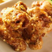 Boneless Parmesan Garlic Wings · Crispy, golden wings tossed in the classic parmesan garlic sauce!