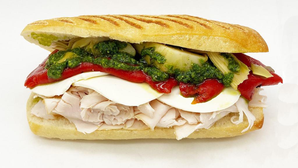 Smoked Turkey Specialty · Smoked turkey with fresh mozzarella, roasted red peppers, artichokes and pesto on a ciabatta roll.