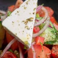 The Villager · Fresh tomatoes and imported feta in a classic greek village salad, exactly as if you were th...