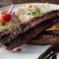 The Kima Kebab Platter · Our specialty! Our blend of lamb and beef ground in house with spices and served with rice, ...