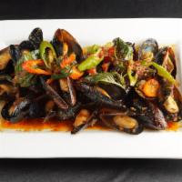 Mussel Prig Pow · Steamed mussels with roasted chili sauce, chili, and basil.