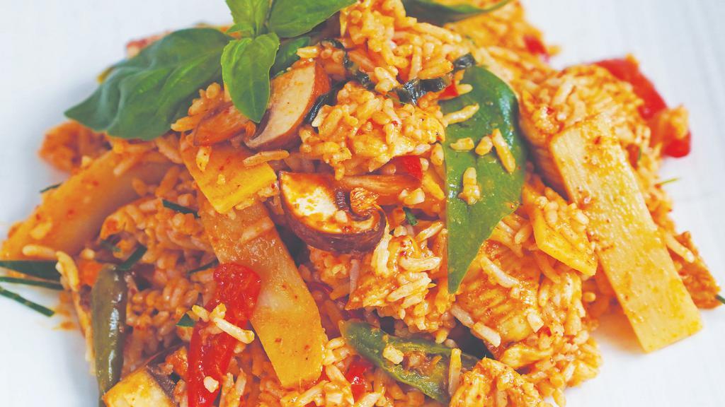 St11. Red Curry Fried Rice · Sauteed protein and jasmine rice in red curry with bamboo shoots, mushrooms, Thai basil, and peppers, with a touch of coconut milk.