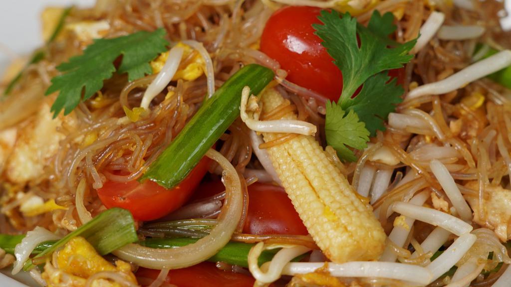 Pad Woon Sen · Glass noodles stir-fried in brown sauce with eggs, onions, baby corn, bean sprouts, tomatoes, and cilantro.