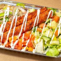 Kofta Kebab Over Rice · Kebab made with ground Chicken and herbs served over brown basmati rice with choice of salad...