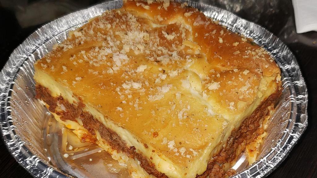 Yia Yia'S Pastichio · Luscious layers of seasoned ground beef, Greek noodles, and a creamy bechamel sauce baked to perfection. This is Greek comfort food at its finest.