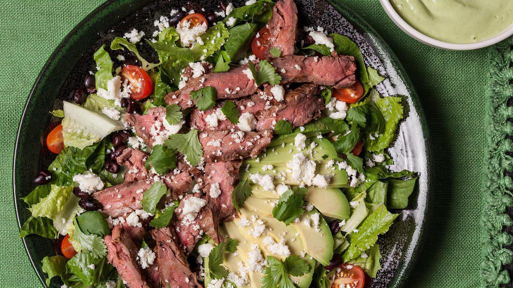 Black & Blue Salad · Certified grass-fed hanger steak served on organic mix greens, tomatoes, avocado, carrots, cucumbers, olives, crumbled blue cheese, Caesar dressing.